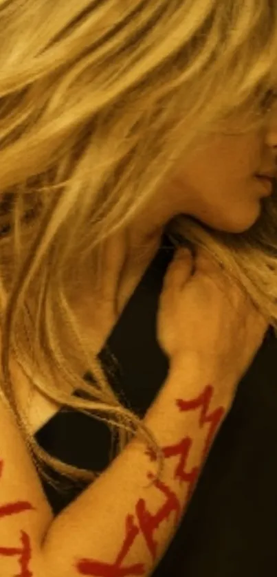 Blonde hair with red art on arm, stylish mobile wallpaper.