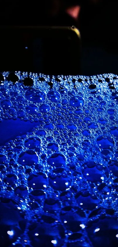 Vivid blue bubble texture on black background.