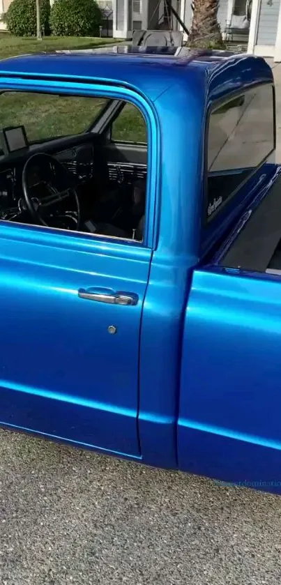 Vibrant blue classic truck parked on a driveway.