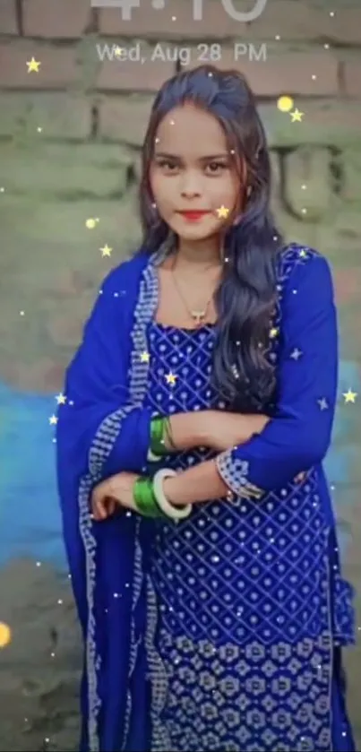 Woman in vibrant blue ethnic attire with a starry background.