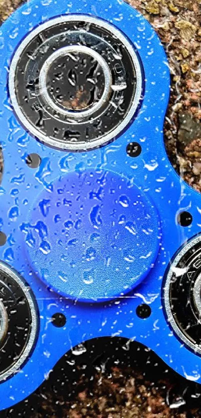 Vibrant blue fidget spinner on textured surface, perfect for mobile wallpaper.