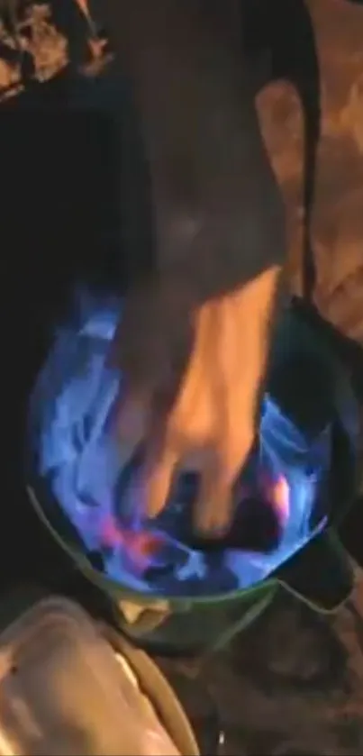 Hand in vibrant blue flame creating a dramatic scene.