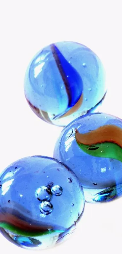 Blue glass marbles on a white background, perfect for vibrant phone wallpaper.