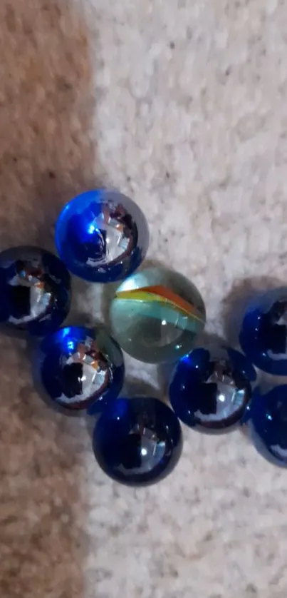 Cluster of blue marbles on a textured surface.