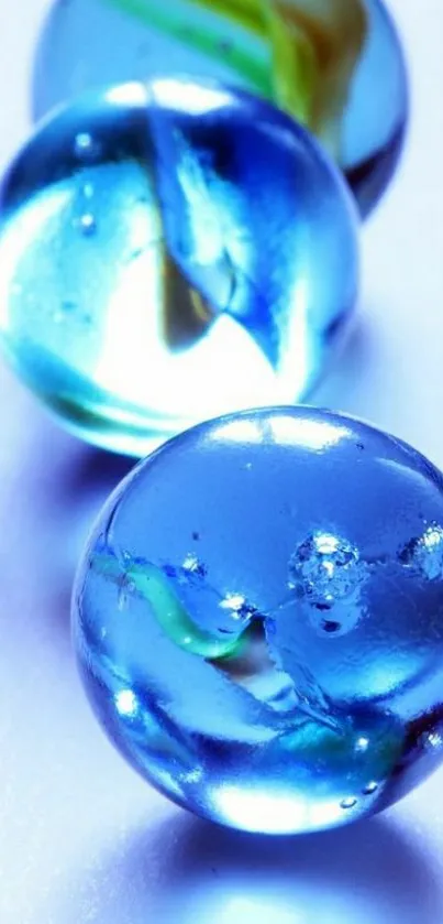 Three glossy blue marbles with striking details.