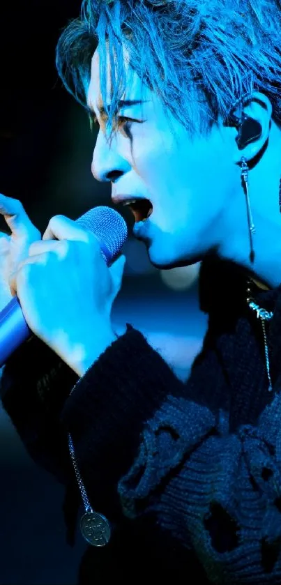 Blue-tinted singer passionately performing on stage wallpaper.