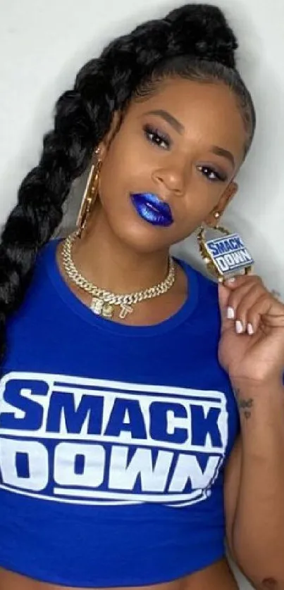 Woman in blue Smackdown shirt with bold lips and braid.