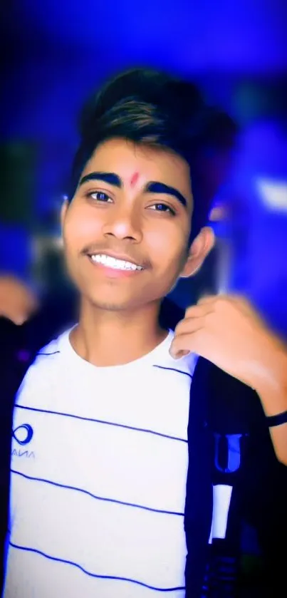 Portrait of a smiling young man with vibrant blue background.