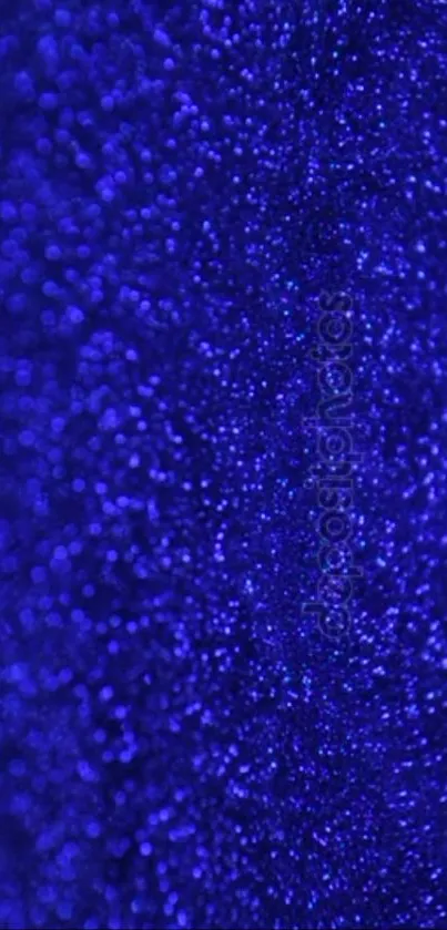 Vibrant blue glitter texture wallpaper with shimmering sparkles.