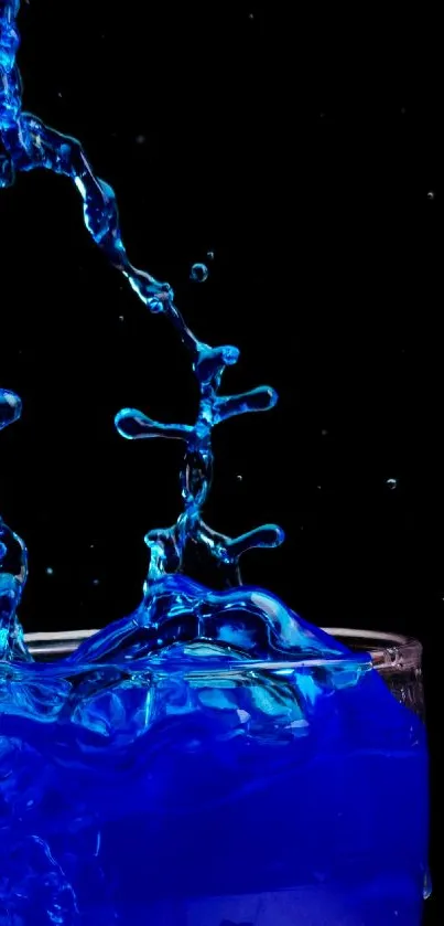 Blue water splash on a dark background, creating a dynamic and artistic effect.