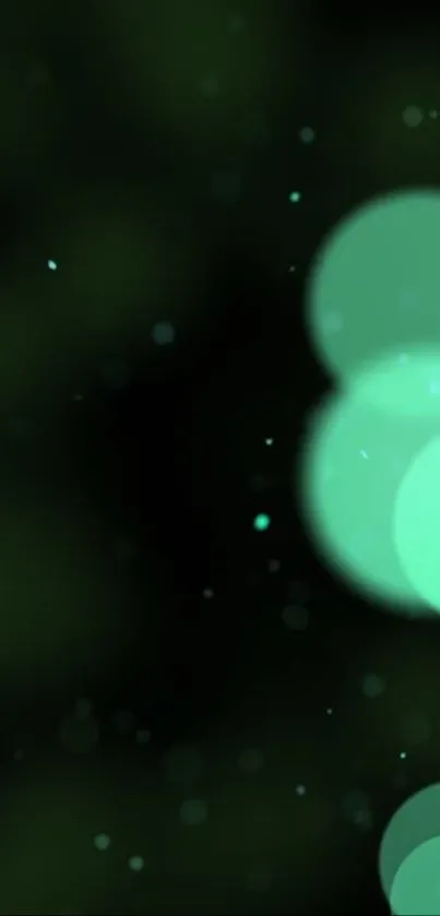 Glowing green bokeh wallpaper with blurred circles.