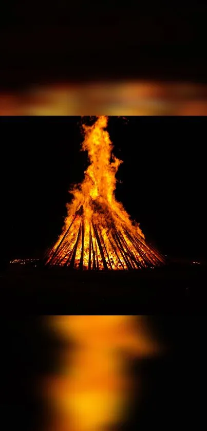 Vibrant bonfire blazing in darkness, creating warmth.