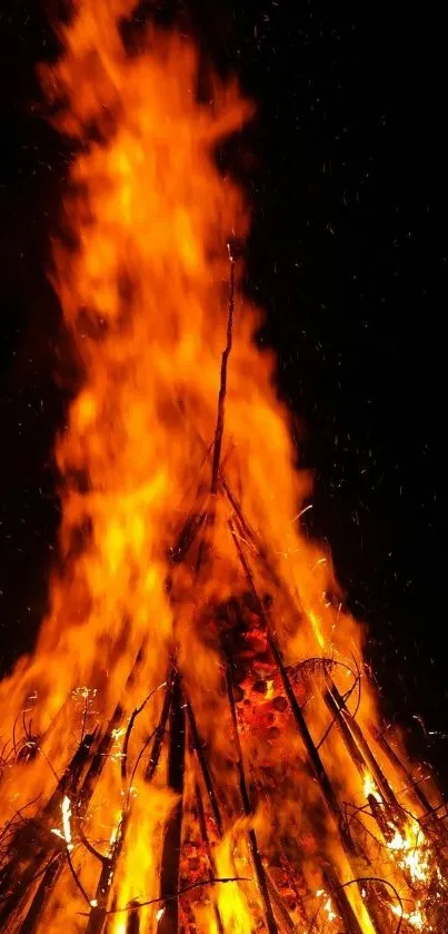 Vibrant bonfire lighting up the night sky.