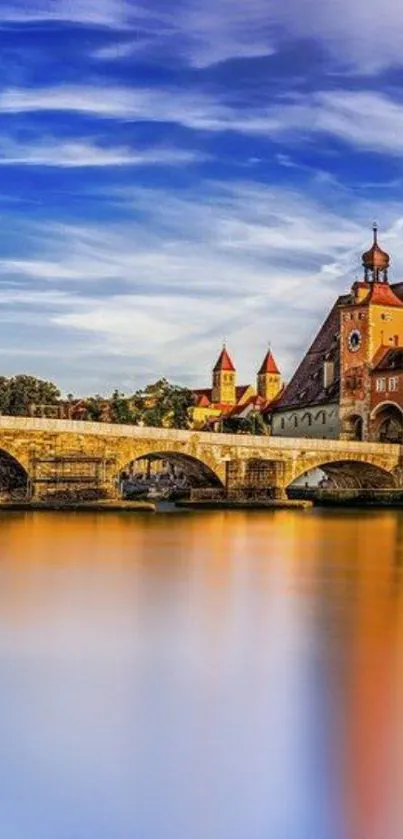 Vibrant blue sky over historic bridge and calm water reflection.