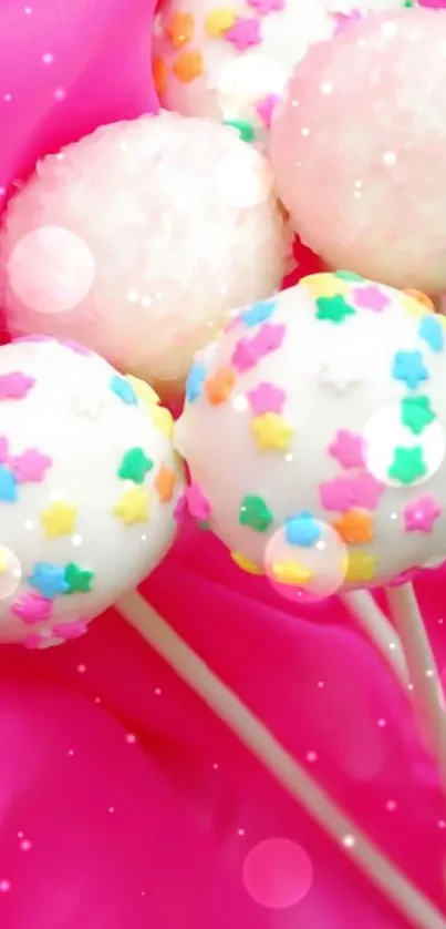 Vibrant cake pops with colorful stars on pink background.