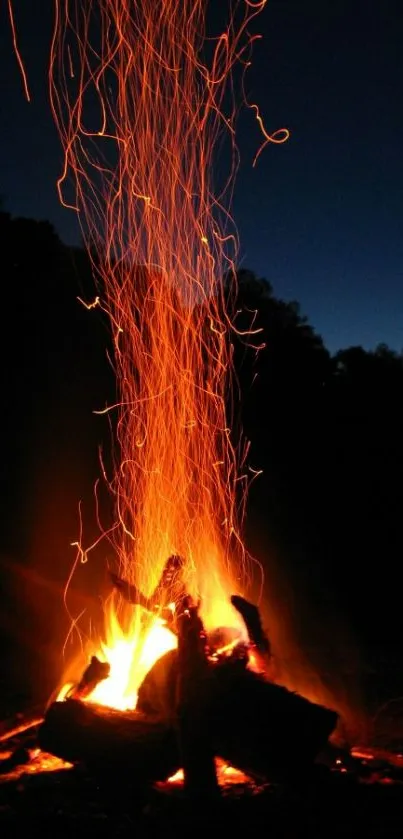 Vibrant campfire with night sky on a mobile wallpaper.