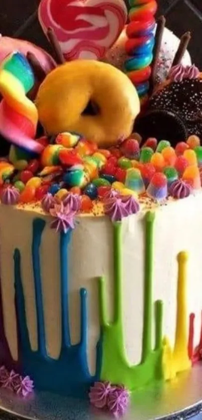 A colorful cake topped with candies and doughnuts.