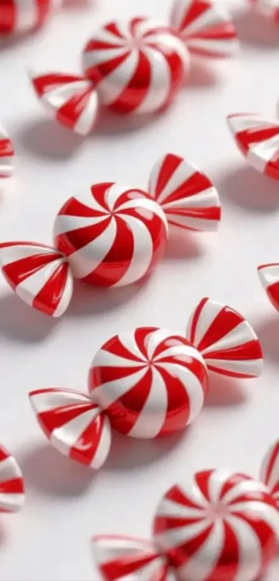 Candy spirals with red and white stripes on a light background.