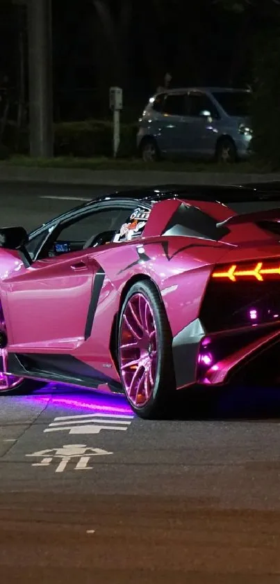 Sleek neon pink sports car on city road at night.