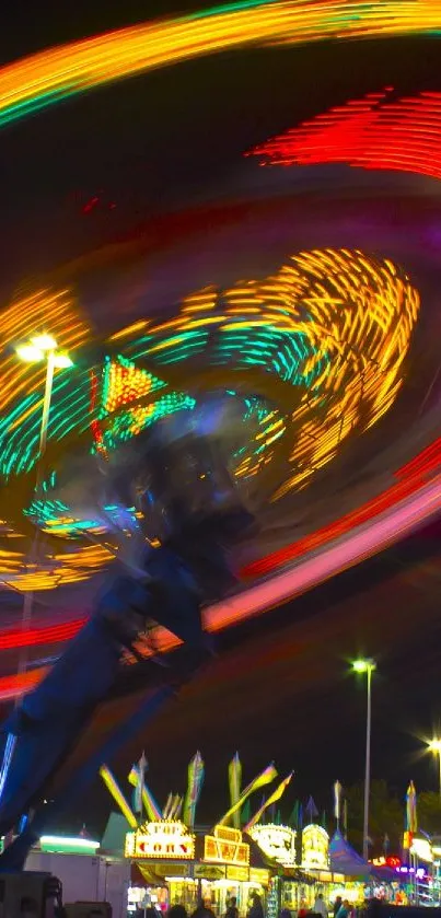 Carnival ride with vibrant spinning lights at night.