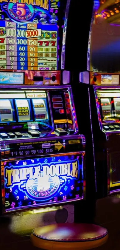 Colorful casino slot machines in neon lights.