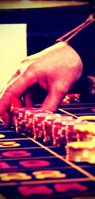 Hand placing chips on casino table in vibrant colors.