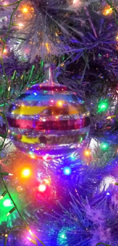 Colorful ornament hanging on a lit Christmas tree.