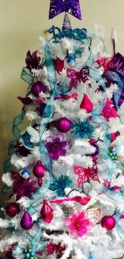 Festively decorated white Christmas tree with colorful ornaments.