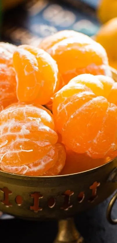 Peeled and whole oranges in a vintage bowl on dark surface.