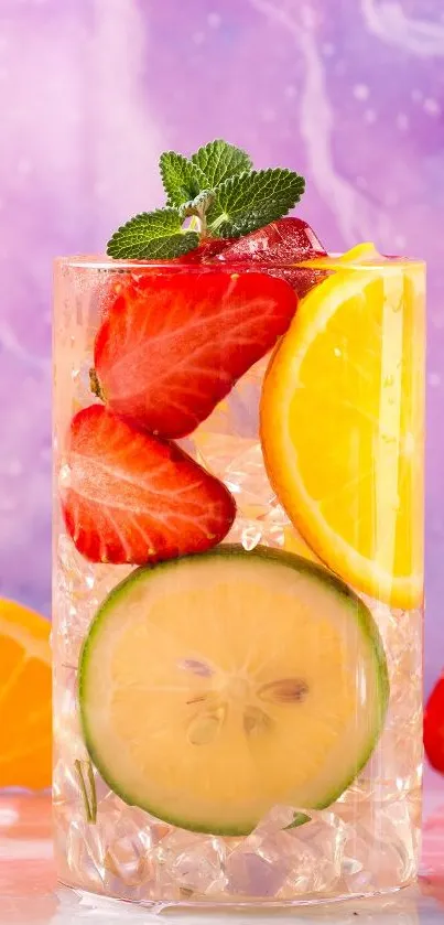 Glass of citrus drink with strawberries and lemons against a purple background.