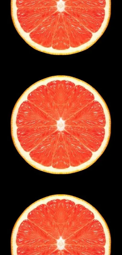 Grapefruit slices against a black background for a vibrant mobile wallpaper.