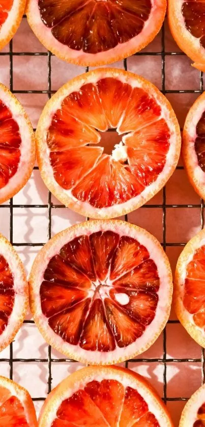 Sliced blood oranges on a grid, creating a vibrant, colorful pattern.