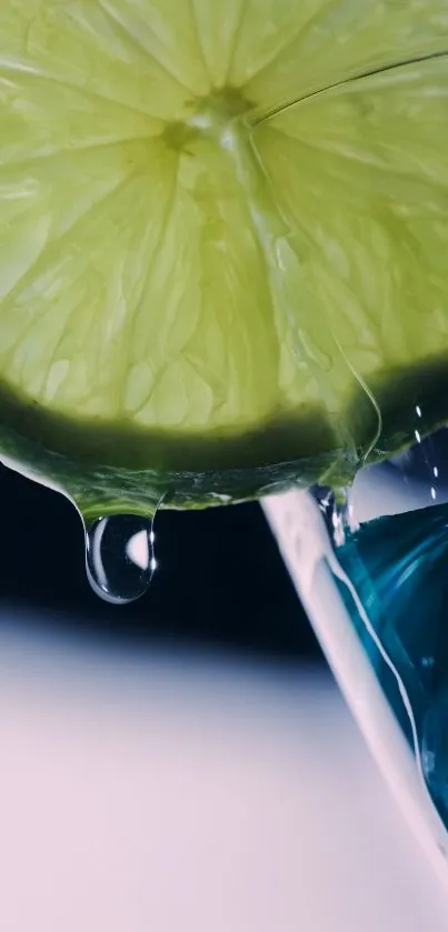 Close-up of lime wedge above a blue glass, vibrant and refreshing design.