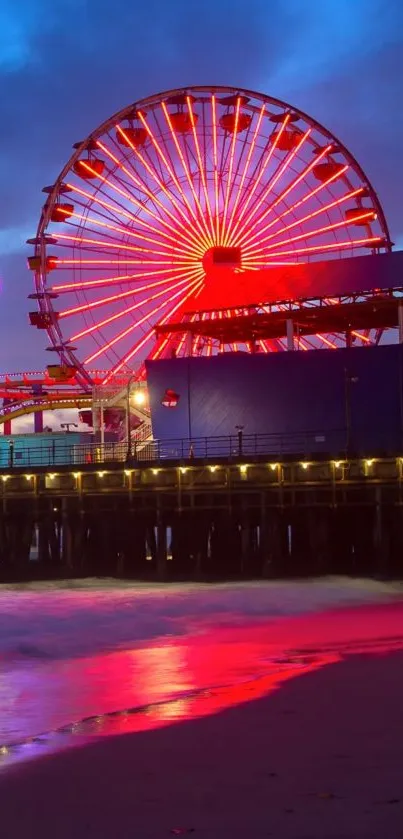 Red Ferris wheel glowing over a city pier at night.