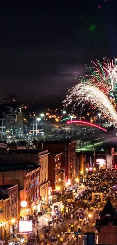 Fireworks over a lively city street at night.