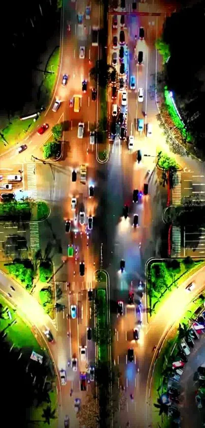 Aerial view of vibrant city intersection at night with colorful lights.