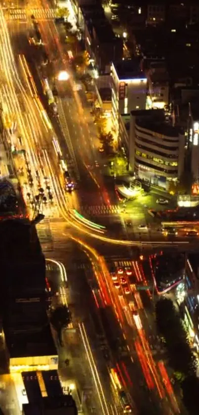 A vibrant city street at night with bright lights and bustling traffic.