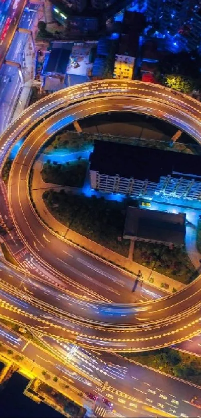 Aerial view of vibrant city lights at night with glowing highways and buildings.