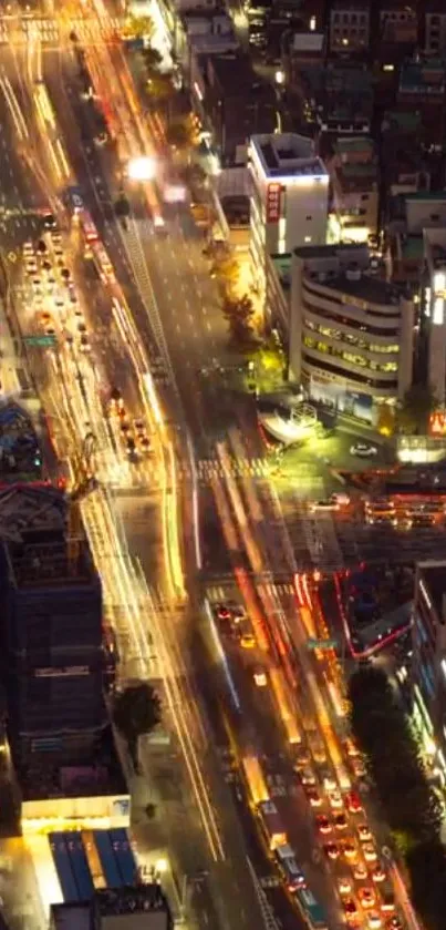 Aerial view of city streets with vibrant night lights and bustling traffic.