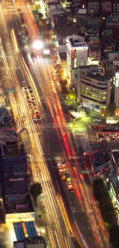 Bustling city street at night with colorful light trails.