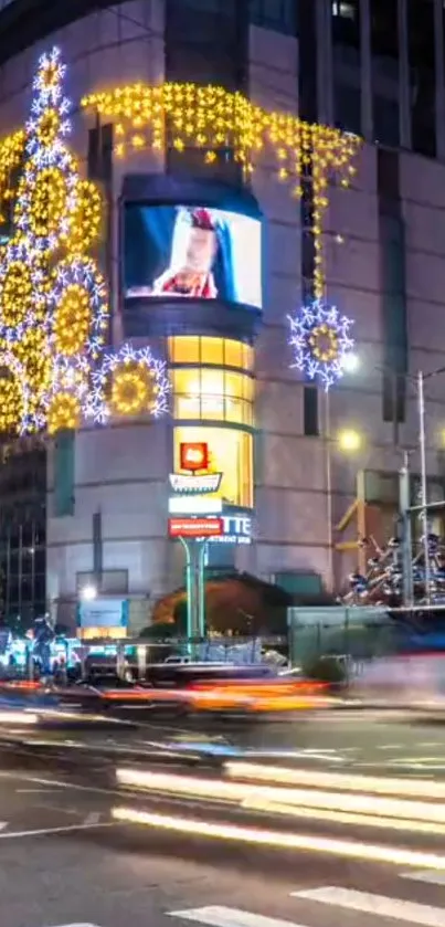 City street at night with festive lights and traffic blur.