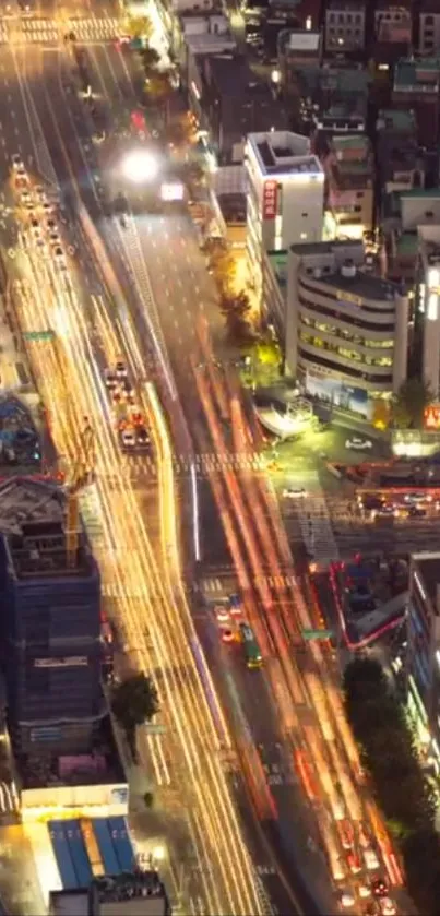 Aerial view of vibrant city lights at night with lively traffic trails.