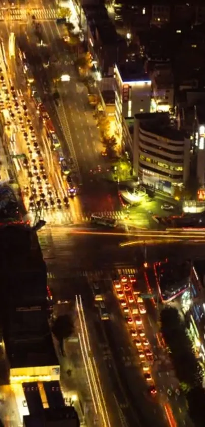 Vibrant aerial view of city lights at night with traffic flowing.