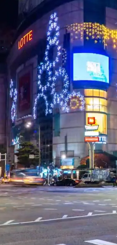 Illuminated city street at night with vibrant urban lights.