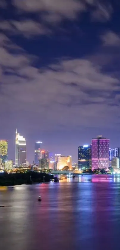 Vibrant city nightscape with colorful skyline and water reflection.