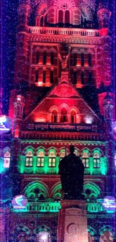 Illuminated historic building at night in vibrant red and green lights.