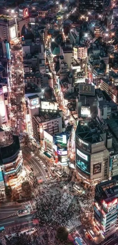 Aerial view of vibrant city streets at night with glowing lights.