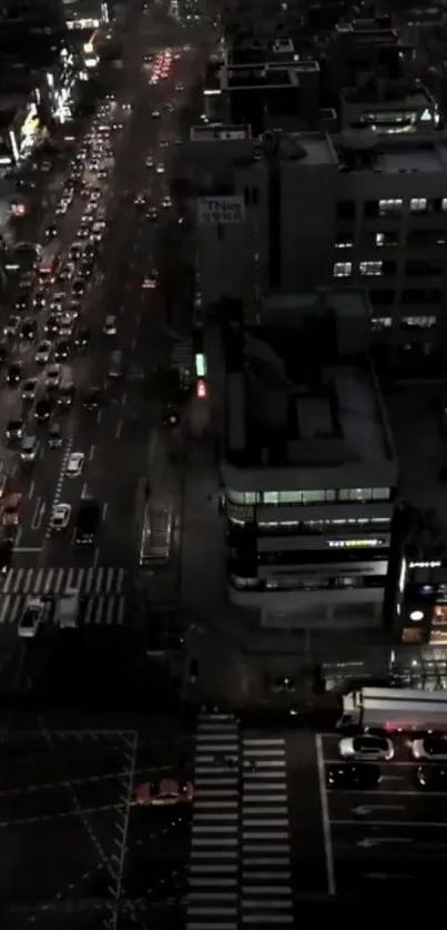 Nighttime city street view with traffic and skyscrapers in dark tones.