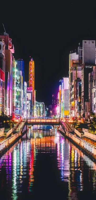 Vibrant city nightscape with colorful neon lights reflecting on a canal.