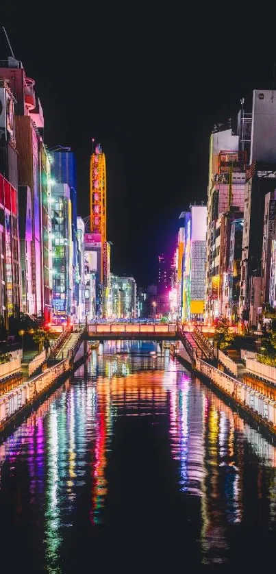 Vibrant city with colorful night lights reflecting on a canal.